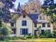 Charming yellow two-story house surrounded by lush greenery at 3471 Whitner Way, Sanford, FL 32773