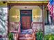 Welcoming front porch featuring classic details, wood railings, a quaint porch, and an American flag at 3471 Whitner Way, Sanford, FL 32773