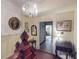 Hallway with chandelier, traditional decor, and multiple doorways leading to various rooms within the home at 3471 Whitner Way, Sanford, FL 32773