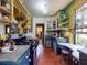 Kitchen with yellow and green shelving, a gas range, terra cotta flooring, and breakfast nook by window at 3471 Whitner Way, Sanford, FL 32773