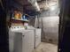 Bright laundry room with white washer and dryer, concrete walls and floors, and exposed pipes at 3471 Whitner Way, Sanford, FL 32773