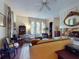 Bright and spacious living room with large windows, in-floor fireplace, and classic furnishings at 3471 Whitner Way, Sanford, FL 32773