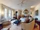 Airy living room featuring an in-floor fireplace, multiple seating areas, and natural light at 3471 Whitner Way, Sanford, FL 32773