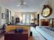 Bright living room with large windows, fireplace, and an ornate mirror above a marble-topped mantle at 3471 Whitner Way, Sanford, FL 32773