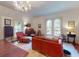 Bright living room featuring classic details, arched windows, and comfortable seating arrangement at 3471 Whitner Way, Sanford, FL 32773