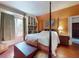 Inviting bedroom showcases a four poster bed, built-in bookshelves, and ample natural light at 3471 Whitner Way, Sanford, FL 32773