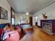 Cozy bedroom features a decorative fireplace, hardwood floors, and comfortable seating at 3471 Whitner Way, Sanford, FL 32773