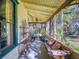 Inviting screened-in porch with wicker furniture, a bench, and a ceiling fan, perfect for enjoying the outdoors at 3471 Whitner Way, Sanford, FL 32773