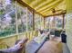 Relaxing screened-in porch with a hanging swing, ceiling fan, and comfortable seating, perfect for outdoor enjoyment at 3471 Whitner Way, Sanford, FL 32773