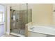 Bathroom featuring a glass-enclosed shower and soaking tub at 3814 Aiden Pl, Apopka, FL 32703