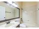 Neutral bathroom featuring a shower-tub combo and large framed mirror above the sink at 3814 Aiden Pl, Apopka, FL 32703