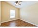 Bedroom with a ceiling fan, window, and wood-look flooring at 3814 Aiden Pl, Apopka, FL 32703