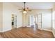 Bedroom featuring neutral walls, wood flooring, ceiling fan, and multiple doorways for easy access at 3814 Aiden Pl, Apopka, FL 32703