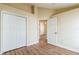 Bright bedroom with hardwood floors, closet, and ensuite bathroom entrance at 3814 Aiden Pl, Apopka, FL 32703