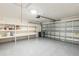 Spacious two-car garage with epoxy flooring and ample storage shelves at 3814 Aiden Pl, Apopka, FL 32703