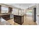 A kitchen with granite countertop, stainless steel appliances, an island, and a view of the pool at 3814 Aiden Pl, Apopka, FL 32703