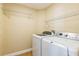 Well-lit laundry room with washer, dryer, and wire shelving at 3814 Aiden Pl, Apopka, FL 32703
