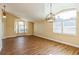 Bright living room with hardwood floors, pendant lighting and large windows with plantation shutters at 3814 Aiden Pl, Apopka, FL 32703