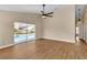Bright living room features wood floors, ceiling fan, and sliding glass doors to the pool at 3814 Aiden Pl, Apopka, FL 32703