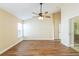 Bedroom with wood floors, ceiling fan, and ensuite bath at 3814 Aiden Pl, Apopka, FL 32703