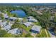 Aerial view of community near a beautiful lake surrounded by trees at 4413 Ring Neck Rd # B, Orlando, FL 32808