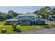 Well-maintained two story townhome with lush green lawn, mature trees, and gray roof at 4413 Ring Neck Rd # B, Orlando, FL 32808