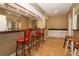 Entertain in style with a wet bar featuring sleek countertops, ample seating and mirrored accents at 626 Orange Dr # 242, Altamonte Springs, FL 32701