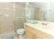 This bathroom features a walk-in shower, a light wood vanity, and neutral colored ceramic tile flooring at 626 Orange Dr # 242, Altamonte Springs, FL 32701