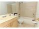 Cozy bathroom features a shower and tub combination with beige tile surround and a light wood vanity at 626 Orange Dr # 242, Altamonte Springs, FL 32701