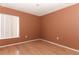 This bedroom features warm paint colors, a large window for natural light, and gleaming hardwood floors at 626 Orange Dr # 242, Altamonte Springs, FL 32701