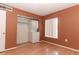 Bedroom featuring a stacked washer/dryer in closet, a large window, and beautiful hardwood floors at 626 Orange Dr # 242, Altamonte Springs, FL 32701