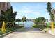 Community boat ramp leading to a tranquil lake, surrounded by green lawns and mature trees under a blue sky at 626 Orange Dr # 242, Altamonte Springs, FL 32701
