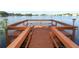 Waterfront property featuring a wooden dock with benches and decorative lighting at 626 Orange Dr # 242, Altamonte Springs, FL 32701