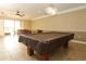 The clubhouse game room provides a billiards table, ceiling fan, and natural light from the outside at 626 Orange Dr # 242, Altamonte Springs, FL 32701