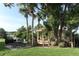 Outdoor gazebo with picnic table and BBQ in a lush, landscaped setting near the water at 626 Orange Dr # 242, Altamonte Springs, FL 32701