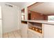 Kitchen with tan cabinets, breakfast bar, tile floors, and pass-through to living area at 626 Orange Dr # 242, Altamonte Springs, FL 32701