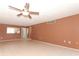 Spacious living room features tile floors, a ceiling fan, and a view to the kitchen at 626 Orange Dr # 242, Altamonte Springs, FL 32701
