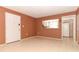 A cozy living room with a pass through view of the adjacent kitchen and a white front door at 626 Orange Dr # 242, Altamonte Springs, FL 32701