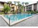 Well-maintained community pool with lounge chairs, landscaping, and palm tree accents at 626 Orange Dr # 242, Altamonte Springs, FL 32701