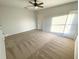 Spacious carpeted bedroom with neutral walls and ample natural light from a window at 734 Fraser Ct, Kissimmee, FL 34759