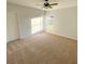 Bedroom with neutral carpeting, a ceiling fan, and a window providing natural light at 734 Fraser Ct, Kissimmee, FL 34759