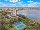 An aerial view of the condo, tennis courts, and lake at 7550 Hinson St # 11C, Orlando, FL 32819
