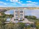 Aerial view of condominium community near lake with beautiful grounds and parking at 7550 Hinson St # 11C, Orlando, FL 32819