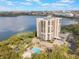 Scenic aerial view of the condominium and community pool next to a lake at 7550 Hinson St # 11C, Orlando, FL 32819