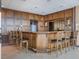 Wet bar area with wood paneling, seating, tile flooring, and granite countertops at 7550 Hinson St # 11C, Orlando, FL 32819