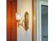 Elegant bathroom light fixture with ornate gold accents and mirrored detail offers a vintage touch at 7550 Hinson St # 11C, Orlando, FL 32819