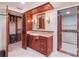 Bathroom with granite countertop, cherry wood vanity, and mirrored medicine cabinet; closet and toilet area at 7550 Hinson St # 11C, Orlando, FL 32819