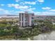 High-rise condo building with multiple balconies and a swimming pool surrounded by lush greenery at 7550 Hinson St # 11C, Orlando, FL 32819