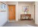 Hallway view featuring a unit door and a decorative console table with flowers at 7550 Hinson St # 11C, Orlando, FL 32819