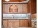 This kitchen features custom cabinetry, granite countertops, and stainless steel faucet at 7550 Hinson St # 11C, Orlando, FL 32819